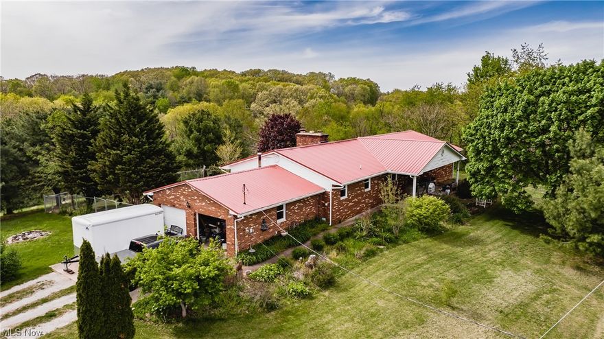 Country living & only minutes from town! Enjoy sitting on the covered front porch sipping your morning coffee or enjoying the warm summer evening! Spacious brick ranch home nestled on just over 4.5 acres. Offering 4 generous bedrooms, 2 1/2 baths, living room, dining room, laundry room, new hard wood flooring, metal roof 2012, new 6" gutters with gutter guards, brand-new chain-link fence 2022, newer windows & exterior metal doors.  The attached garage boasts an ample 26x24 as well as a separate 56x32 pole building with workshop including heat, a/c concrete flooring, electric, gas & water available. Septic was last inspected 2022. Water Heater 5 yrs old, HVAC 5 yrs old. Warren School District. *** Recent APPRAISAL****