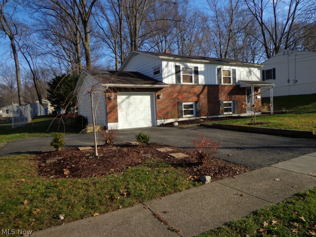 This well kept Bi-level on a lovely lot is across the street from a park & playground. Outdoor entertaining is welcomed with a large stamped concrete patio that was installed in 2010. The nicely shaded back yard has ample room for outdoor play and activity with a storage shed. The impressive inside updates are added values including Water Heater (2014), Dishwasher (2013), Refrigerator (2009), windows (around 2006), Custom plantation blinds to match trim work, ceramic tile bath with Jetted tub, and new front door. Kitchen has a movable island and appliances in that room stay. Entrance from garage has a mudroom/utility area that is great for those winter months.