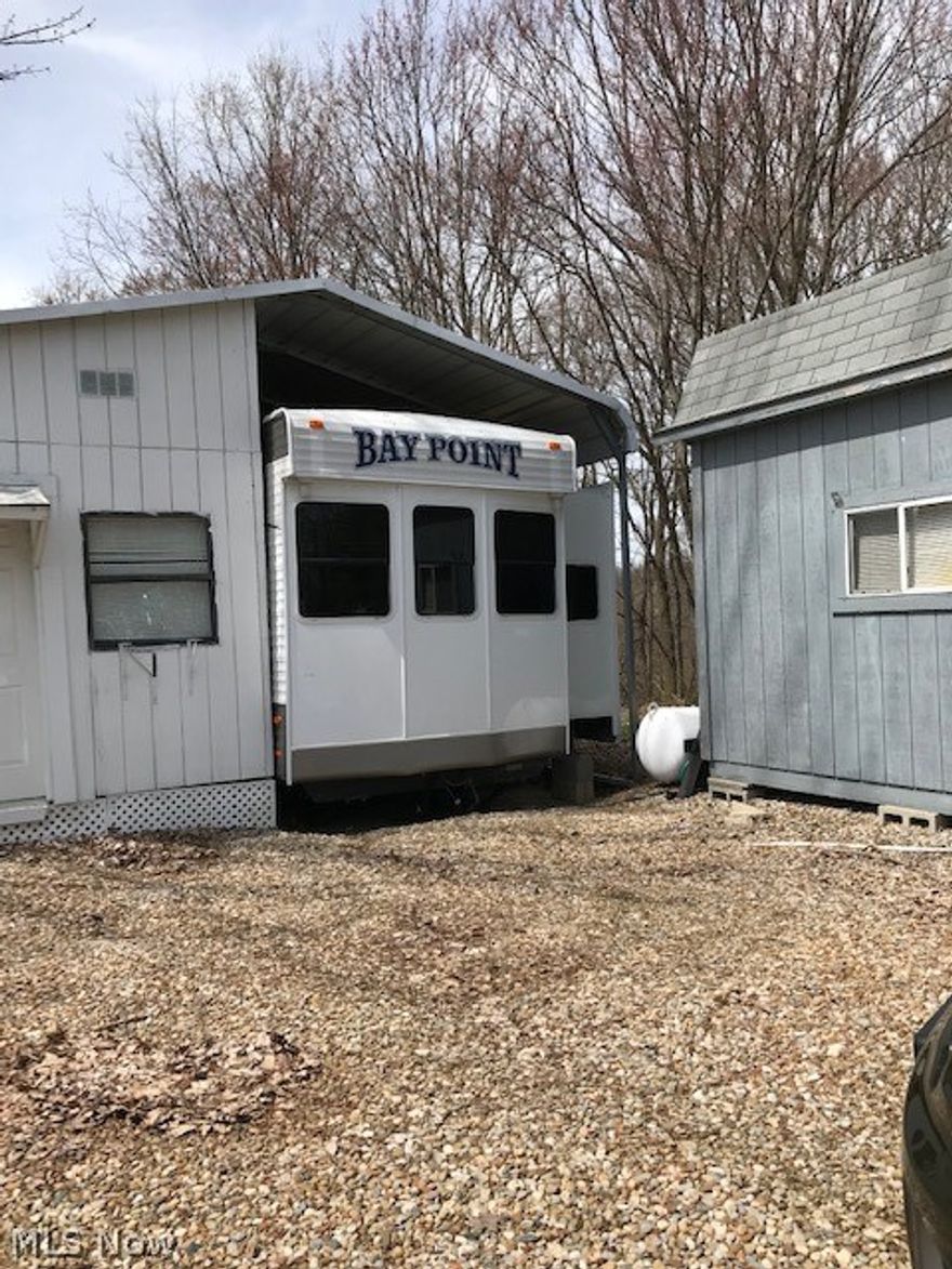 Own your own lot in October Hills and enjoy the Club House, heated pool, basketball and volleyball courts, 2 play grounds and shuffle board. Included is a 2016 like new 38 FT camper with 2 slide outs, all appliances included. 2 bedroom, full bath with shower/ tub, electric fireplace and much more!