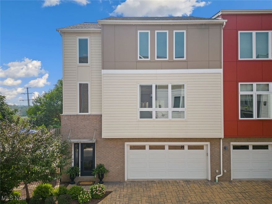 Rare Opportunity!! Welcome to Bergen Village, the only gated community in Tremont!! One of largest units with 2800+ sq.ft. & the ONLY home in the community with a rare, 2nd full size lot, offering a huge, fully fenced in private yard w/ a newer stamped concrete patio & professional landscaping - and it's still maintained for you by the HOA! Perfect for dog owners & those who like to entertain. Truly a rare find for city living! The main floor has an attractive open floor plan, tall ceilings, floor to ceiling windows & beautiful engineered hardwood flooring.  Luxury kitchen w/custom cabinets, newer stainless steel appliances, quartz counters, tile back-splash, a huge island w/ prep sink & bar area. Large wrap around deck off kitchen constructed of composite decking & vinyl railing - think low maintenance for many years! Upstairs is the primary suite with vaulted ceilings, a Juliette balcony, a walk-in closet & the luxury primary bath featuring a dual sink vanity, beautiful tile shower & separate washroom. The second bedroom upstairs is a nice size w/dual closets & comes w/ its own full bath featuring a combo shower/tub, tile flooring & vanity w/granite countertops. The laundry closet & an office nook complete the 2nd floor. The first floor has a Flex room (3rd bdrm) w/an en-suite full bath, that would make an excellent rec room/play room, guest suite/in-law suite. You'll enjoy the luxury of the tankless hot water heater! The garage is oversized, has a drain & provides additional storage space. You will love all the large windows that flood the space w/ natural light in this home + the motorized blinds in the great room! Fantastic Location!! Adjacent to the Towpath trail, in the shadows of the City Skyline & just blocks away from all the awesome restaurants, bars, shops, arts & community events that Tremont has to offer. TAX ABATEMENT through 2031!! Truly a great value!! The Best of City Living! See virtual 3D tour and schedule your private tour today!!