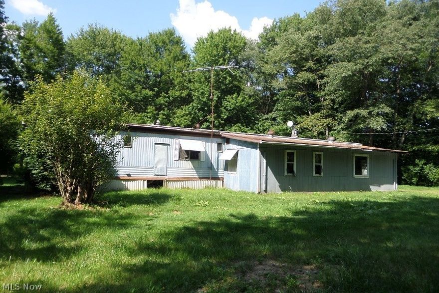 Bank owned!! This is NOT a short sale! Fast and easy process! Quick seller response time! This property would make that perfect weekend getaway for HUNTING! Lots of woods! Or need a place to store your cars, atv's, boats or campers??? There is an amazing 40x30 detached garage with a concrete floor and electric! County says it was built in 2002. The trailer on the property probably should be torn down unless you would like to repair it. Would be perfect to move a new manufactured home here (please check with zoning) or build a new home!  Nice wooded private setting w/ cool tree lined driveway! Offers will not be reviewed until the property has been listed on the MLS for 7 calendar days.All offers require a minimum earnest money deposit of $1,000.00 or 1% of purchase price, whichever is greater; any offer submitted without the required minimum amount will not be considered. Seller requires proof of certified earnest money deposit, Lender pre-qualification letter or proof of funds w/ all