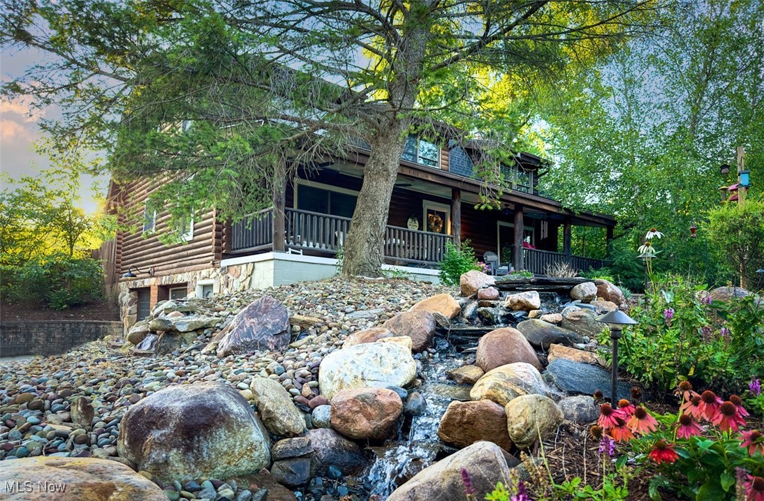 Welcome to 3536 Watkins Rd, where rustic charm meets modern luxury. This updated log home offers tranquility and contemporary living on nearly 5 acres in Medina Township w/ public water! The open-concept main floor features a great room with a floor-to-ceiling stone fireplace, hardwood floors and vaulted ceilings. Enjoy cozy evenings by the energy-efficient fireplace insert (2021). Automated lights and fresh paint, have been updated throughout the home. The kitchen is a dream with new stainless-steel appliances. Granite countertops and a large, eat-in island add to the appeal. The lighted, step-in pantry (2023) offers ample storage, while the dining room boasts stunning backyard views. The first-floor master suite includes dual vanities, a gorgeous walk-in shower and a redesigned closet. The second floor features a spacious loft overlooking the great room, another full bath and three large bedrooms. The lower level has a large laundry area with new countertops, cabinets and a utility sink. It also includes a remodeled full bath with updated plumbing and electrical (2024) and a Dolby Atmos home theater. The backyard oasis features a newly built deck (2024), updated patio lighting, an outdoor speaker system and a split rail fence with two access gates. Enjoy the stocked swimming pond, sand beach and a finished lake house with a bar and A/V system, perfect for entertaining guests. The front of the property showcases Canyon Creek hardscaping, an automated waterfall, updated lighting and flagstone steps. Take in nature from the peaceful front porch, with views of the spacious pole barn featuring concrete flooring, high ceilings, lighting and electric. Additional upgrades: New roof (2020), hot water tank (2020), Carrier AC & furnace (2019), 240V EV charging drop and fiber optic internet for seamless connectivity. Located in Medina Township, just minutes from shopping and dining. NO RITA TAXES. Schedule your private tour today, properties like this don't come up often!