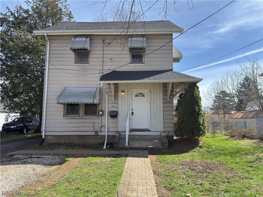 This recently rehabbed Goodyear Heights Colonial has new carpet, fresh paint and is ready for new owners to move in and call it home. The fully enclosed front entry provides a warm space to ready yourself for the elements or welcome friends and guests with a cozy reception. On the main floor, you'll find a kitchen, living room, and bedroom suite with a half-bath. From the kitchen, take the door to the side yard and let the dogs out to enjoy the fully fenced side yard all to themselves. Upstairs are three more bedrooms, a full bath, and built-in cabinets galore. This property has a two-tiered and fully fenced backyard perfect for a sandbox, greenhouse, swing set, garden and more. Located within steps of the Goodyear MetroPark, and only minutes away from shopping and highways, you'll spend less time commuting and more time relaxing from the comfort of home and exploring the nearby trails.