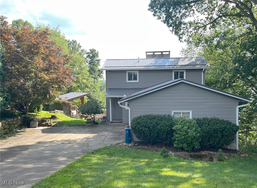 Looking for a change in lifestyle? Welcome to 39 Pueblo Trail. This unique lake home at Lake Mohawk, in Malvern, OH, offers beautiful lake views, three levels, and outdoor entertaining spaces. The Amish built pavilion is perfect for relaxing and enjoying the sights of water, sun and fun. The property has frontage on two streets and the lot is oversized 113' x 268', with plenty of privacy.
Inside you'll enjoy the great room on main level with fireplace, dining area and access to a spacious deck. Extra wide staircase leads to the master suite that has private bath, walk-in closet, fireplace and loft area. Lower level offers walk-out, four season room, another bedroom, full bath and laundry area. This wonderful lake home has been well cared for and has had numerous improvements: Pavilion w/ metal roof and gutter with leaf guards in 2020. Metal roof on home in 2021. Main level deck and railing in 2021. Electrical panel with whole house surge protector in 2022. New flooring on main level and lower level in 2023. Updated two bathrooms and many other improvements. Lake Mohawk has 500-acre lake for boating (unlimited horsepower), swimming, fishing, tennis court, pickleball courts, clubhouse and baseball field. Separate membership available for golf course. Convenient to Akron, Cleveland and Pittsburg areas. Electronic surveillance equipment on the premises.