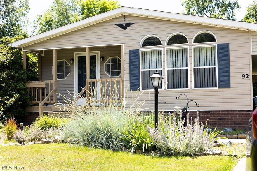 Nestled in on a cul-de-sac in one of the most desirable parks in Geauga County, is 92 Greentree Lane in Hiram. This 1352 sqft, 3 bedroom, 2 bathroom modular home, featuring a 2 car carport is completely move-in ready; it even comes fully furnished! Enter the home from the front porch into the open-concept living space, featuring a large living room, separate dining area, and fully
equipped, brightly lit kitchen. The sizable main bedroom features an en suite bathroom with double sinks, a jacuzzi tub, and a separate shower. Down the hall is a utility room with a washer and dryer, two bedrooms, and a full bathroom. The lot, located near one of the ponds in the park, comes with an oversized storage shed in the back and firepit. There will be a presale inspection provided for buyers. Information about mobile home lenders is available. Homes in Troy Oaks Club do not last - and this one is a gem! Make your appointment to see it today!
