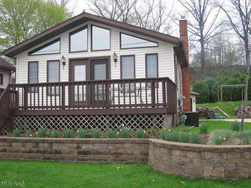 Enjoy Portage Lakes and a fine home.  This vinyl sided home with a dock on Boat Drive and  lake and beach access offers many improvements and updates including all new carpet, fresh interior paint.  Amenities include 2 fireplaces, a family room with cathedral ceiling and wood burning stove.  A spacious living room with cathedral ceiling, walls of windows and a sliding door to the deck with lake view. The ample sized master bedroom with gas fireplace, a loft, 2 full bathrooms, a fully applianced kitchen, a splendid deck, lake view, private back yard, oversized attached 2 car garage, newer gas furnace, central air conditioning, vinyl windows, newer well holding tank, Security System, updated electrical service panel and is wired for a generator, newly lined chimneys with caps and more.