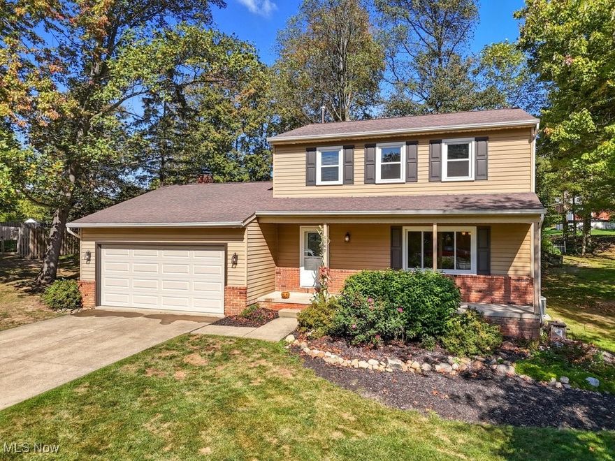 Your search is over!  The 3 bedroom, 2 ½ bath Colonial that you have waited for is ready for you to call "home" and is nestled on a half-acre of "peaceful" and surrounded by mature trees.  This home has been remodeled and updated from top to bottom and offers a perfect blend of timeless comfort and modern style. Step inside from the spacious front porch, into the welcoming foyer where new Luxury Vinyl Tile flooring (2025) flows seamlessly from the kitchen right to the dining room for special celebrations with family and friends. The heart of this home has always been the family room featuring the floor-to-ceiling fireplace, promising cozy evenings. The eat-in kitchen is fully equipped with all appliances, including a new dishwasher (2025), and features a sliding door(2022) that opens onto the large deck, ideal for outdoor dining and relaxing evenings. The first floor has been painted and is waiting for your touches of color. A formal living room and a convenient half-bath complete the main level. Upstairs, the primary suite is a private retreat, featuring a fully renovated ensuite bathroom (2020) with a modern walk-in shower.  Two additional bedrooms offer spacious closets and share another beautifully updated full bathroom (2020). The impressively finished lower level (2021)provides plenty of additional living space for another family room, game room, home gym or office. Outside, the  spacious deck was just restored (2025) and overlooks a deep yard with plenty of green space for littles, pets and fall fun in the sun. The attached two-car garage includes a finished attic with pull-down ladder offering excellent storage solutions. More updates include: New windows throughout, shutters and entry doors: - 2022, HVAC System: 2016 . Located in the thriving community of Macedonia, known as the "The Crossroads of Northeast Ohio" you're just minutes from plenty of shopping, restaurants, recreation and easy access to downtown CLE.  Everyone has a story...begin yours here~