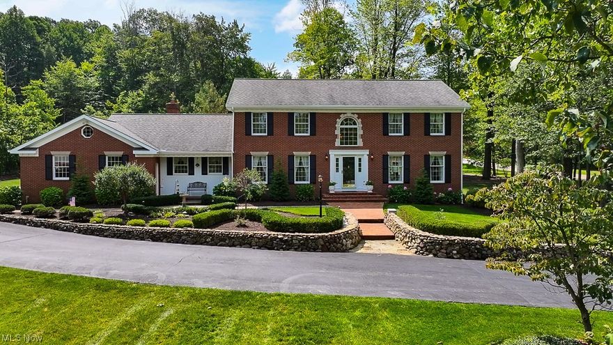 Experience luxury in this meticulously crafted Bentley Builders custom brick Georgian colonial, nestled at the base of Historic Little Mountain. Enjoy views of Lake Erie from the 2nd floor of this stunning home. The property spans two acres of park-like grounds, creating a backyard oasis with brick stone pavers, pond, stone water fountain & screened-in gazebo complete w/ a fire pit. Inside, find a grand two-story foyer entrance. Fine millwork and quality details are evident throughout, w/ white oak flooring milled from trees on the property. The kitchen is a dream, featuring an island with a Jenn-Air grill, two Sub-zero built-in refrigerators, double ovens (one convection) & a built-in microwave. The family room features a vaulted ceiling, skylights, fireplace & wet bar. An office with oak flooring & custom mahogany French doors w/ stained glass inserts offers an elegant retreat. The master suite boasts a vaulted ceiling, glamour bath & walk-in closet, while 3 additional large bedrooms share a full bath on the 2nd level. The basement provides ample entertainment space, w/ a huge recreation room with a wet bar & refrigerator & a billiard room. A full updated bath, wine closet, sauna & a workout room complete the lower level. Garages include an attached, heated 3-car garage, as well as a detached heated 2-car garage. Notable updates include a new roof 2013, updated septic system in 2019 & new twin zone furnaces 2018. Don't miss the chance to make this luxurious estate your own!