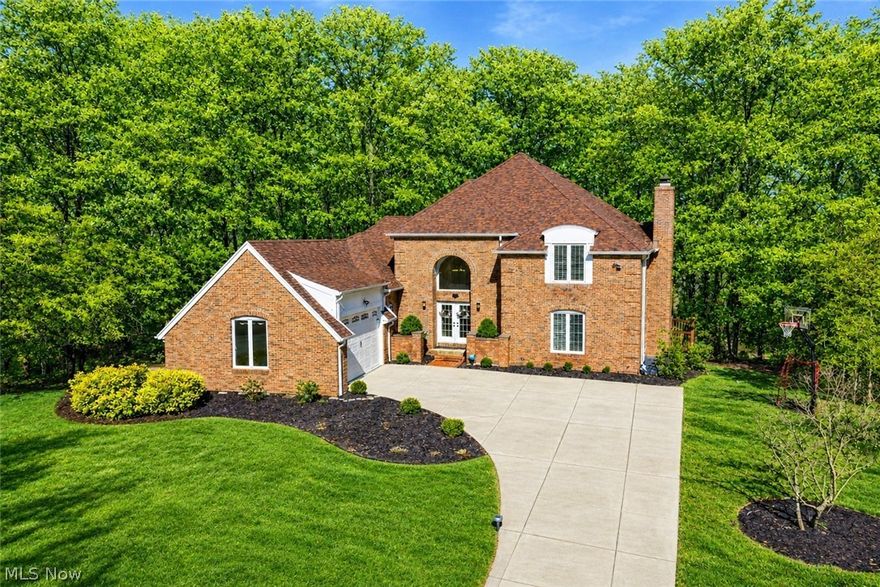 Beautiful Rare All-Brick Colonial home located on a private cul-de-sac in the highly desirable Lakes of Aurora. This meticulously maintained 4-bedroom, 4-bath home offers Elegance, Functionality, and Timeless Design with 9 ft. ceilings and hardwood floors throughout the first floor. As you enter, you are welcomed by impressive double doors leading into a grand two-story foyer featuring a timeless staircase design that sets the tone for the elegance throughout the home. Stylish interior French doors off the living room offer the perfect balance of privacy and openness, close them for quiet separation or open them to enhance the home’s open flow when entertaining. A newer gas fireplace with remote control adds a cozy touch. The spacious kitchen is designed to impress with cherry cabinetry, new Quartz countertops, high-end Viking dishwasher, 6-burner gas stove with a dual-motor stainless-steel chimney, double convection ovens, wine cooler, and a charming breakfast nook. A conveniently located half-bath and first-floor laundry adds to the everyday practicality and ease. The first-floor primary suite is a true retreat, offering a private deck, a spa-inspired bath, new quartz countertops and fixtures, a relaxing jetted soaking tub, and a spacious walk-in closet. An adjoining private office or flex space with a premium gas fireplace installed 2023 add comfort. Upstairs features three spacious bedrooms including a Jack-and-Jill bath. The finished lower level offers a spacious entertaining room with a half-bath, a fitness area and abundant storage. Outdoor living is unmatched featuring an expansive deck restored in 2025 overlooking a private wooded park-like setting on .63 acres. Enjoy all the amenities the Lakes of Aurora has to offer, including two pools, tennis courts, clubhouse, walking trails, gym, playground, lakes, and annual community events. Nothing to do but move right in and enjoy luxury living in a splendid home in one of Aurora’s most sought-after communities.