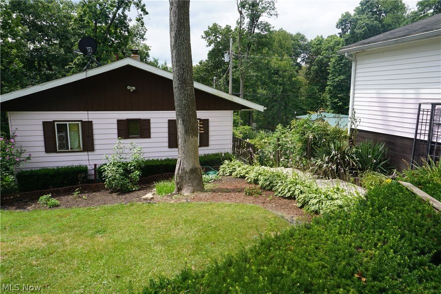 Nice home with two car garage includes 6 lots.  Located in VoAsh Lake community which is only available for residents to use the lake. This three bedroom, two bath home is perfect for full time lake living or ideal for weekend getaways.  Updates include kitchen counter, backsplash, and newer stainless refrigerator. Large lower level family room with sliding glass door to private patio. Main level has wonderful covered deck for enjoying year round water views. Electrical updated and roof is approximately 4 years old. Great fishing (stocked lake), kayaks, canoes are allowed on lake  There is a private clubhouse, beach area and playground for residents to enjoy.  The road maintenance, water and trash services are provided by the lake association and HOA fees are $660.00 per year.  This property is located near three other sporting lakes: Leesville Tappan and Atwood.