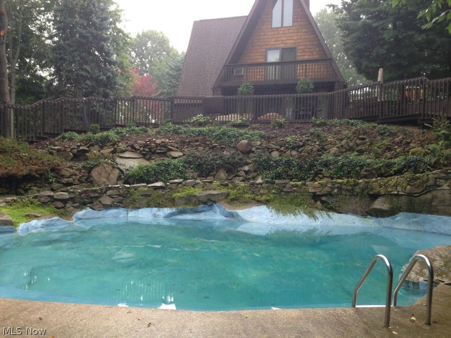 This "A" frame sits on a large lot with an in ground stone pool w/pool house and detached 2 car garage. Every bedroom has a balcony with a beautiful view. The family room and living room both have brick fireplaces.  There is nothing to do but move in and start entertaining.