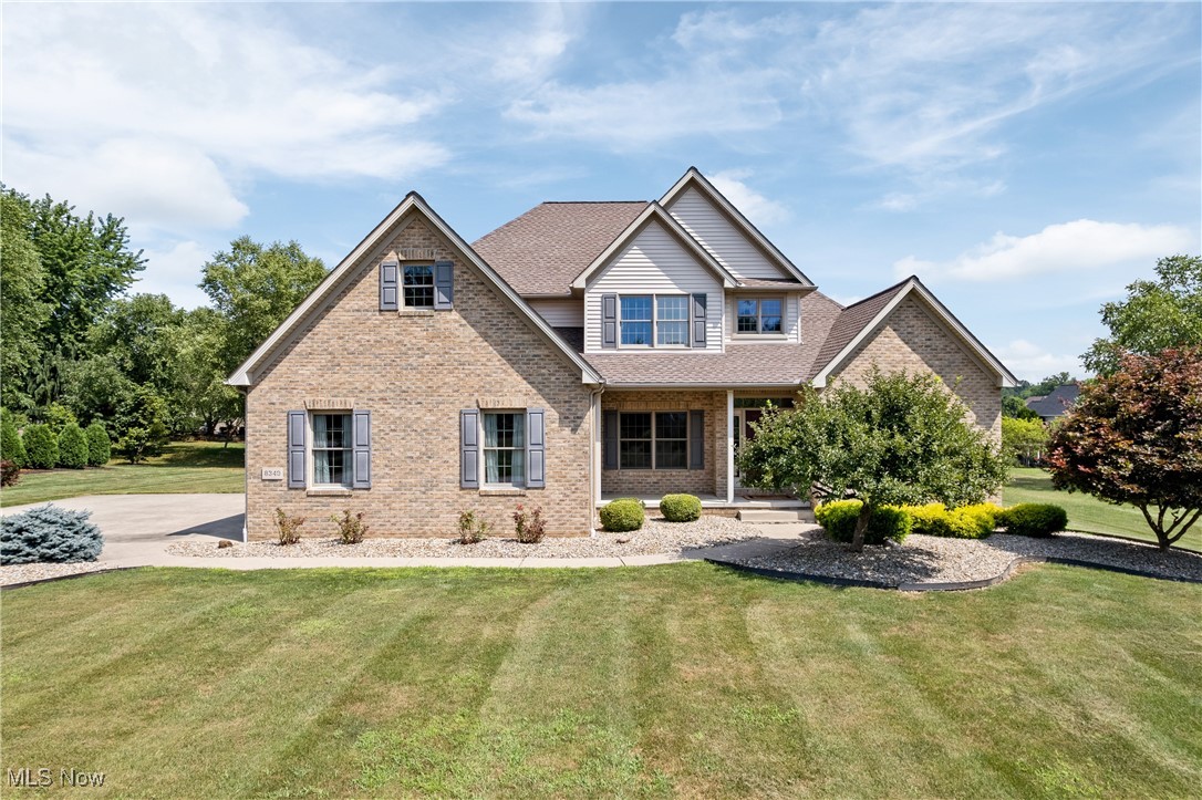 Welcome to your dream home in the desirable Coventry Hills neighborhood! This beautifully maintained Colonial offers timeless charm, thoughtful design, and fresh updates ready for you to move right in. Step into the welcoming foyer, where classic elegance meets modern comfort. To your left, enjoy formal dinners in the spacious dining room; to your right, a sunlit office provides the perfect work-from-home setup. The two-story great room is a showstopper, featuring a cozy gas fireplace and soaring ceilings that fill the space with natural light. The open-concept kitchen is a chef's dream, complete with granite countertops, stainless steel appliances, a large island, and ceramic tile flooring. The bright eating area opens to a stunning stamped concrete patio, ideal for outdoor entertaining or quiet mornings with coffee. It overlooks beautifully manicured landscaping and a lush lawn. The first-floor primary suite offers a luxurious retreat with a spa-like bathroom featuring a soaking tub, separate shower, and walk-in closet. A guest half bath and laundry room complete the mail level. Upstairs, you'll find three additional bedrooms, a full bathroom with double sinks, and a spacious bonus room that can serve as a fifth bedroom, playroom, or media space. The full basement provides endless possibilities with generous recreation areas and ample storage. With modern upgrades and move-in readiness, this home checks every box. Schedule your private showing today and fall in love with everything it has to offer!