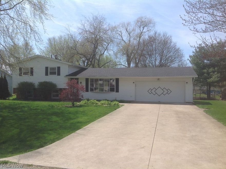 This well-maintained 3 bedroom, 2 full bath, split level is on a quiet street in Perry Local Schools and is move-in ready! The spacious walk out lower level features a full bathroom, a wet bar, brand new flooring, and a wood-burning fireplace. The main floor includes a beautiful bay window offering plenty of natural light and original hardwood flooring. The three bedrooms upstairs each have ceiling fans and brand new carpet. Also included is a spacious 2 car garage and wide driveway. This one is priced to sell, get it before it's too late. Set up your private showing today so you can be in your new home for the holidays!