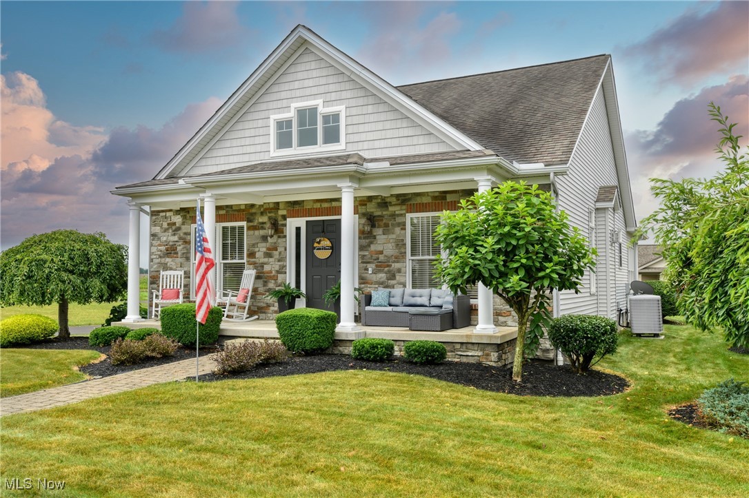 Welcome to this beautifully maintained 3 bedroom 2.5 bathroom villa located in the heart of Columbiana. Offering 2,371 square feet of thoughtfully designed living space, this home combines comfort, style, and functionality in a highly desirable layout. Step into the impressive foyer with soaring 15 foot ceilings, setting the tone for the open and airy feel throughout. The great room features a cozy fireplace and is flooded with natural light-perfect for relaxing or entertaining guests. Enjoy cooking in the large kitchen, complete with included appliances and plenty of counter space for meal prep and gatherings. The first floor laundry adds everyday convenience. The first floor primary suite is a peaceful retreat, boasting a luxurious en-suite bathroom with a tiled shower, custom soaking tub, and double sink vanity. Upstairs you'll find 2 additional bedrooms and a full bathroom. Whether you're downsizing, relocating, or looking for a move-in ready home in a prime location, this villa checks all the boxes!
