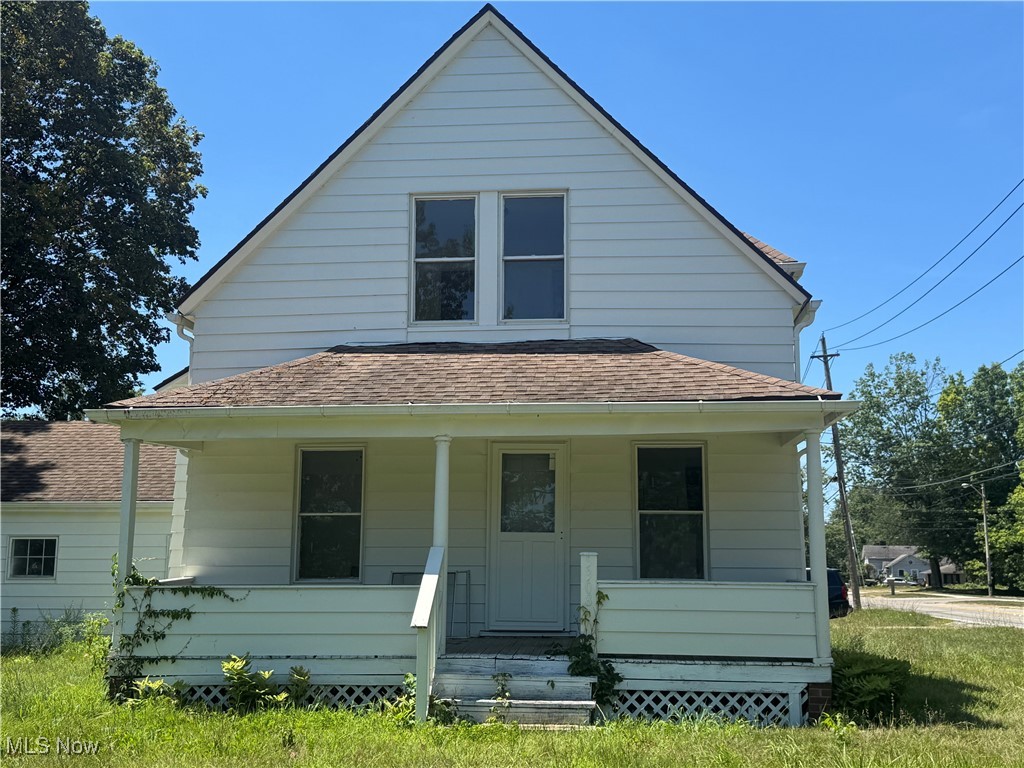 2 Bedrooms Vinyl Cape Cod with attached 2 car garage . Home need updates !