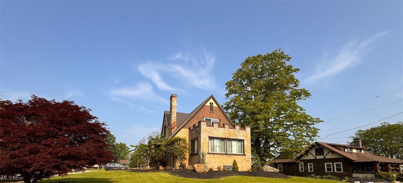 This charming Cape Cod home in Cadiz, Harrison County, Ohio, is a distinctive property built in 1918. Nestled on a 0.28-acre lot, it is uniquely bordered by paved streets on all four sides. The two-story residence offers 3,094 sq. ft. of living space, featuring a full basement, three spacious bedrooms with ample closet storage, and two full bathrooms with tub/shower combinations on the main floor. Recent upgrades enhance comfort and durability, including a new metal roof installed in 2023. In 2024, improvements included an upgraded sunroom, laundry room, fresh landscaping, a new concrete patio and driveway, and all-new Window World windows, screen doors, and back entrance door. The upstairs bedrooms have private balconies with newly installed sliding glass doors, ideal for enjoying beautiful sunrises or sunsets. The balcony roofs were replaced with durable materials, allowing safe use without compromising structural integrity. A versatile sitting area between the upstairs bedrooms and bath serves as a play space or quiet reading nook. The main floor showcases hardwood floors in the dining room, living room, and sunroom. The spacious living room features a fireplace, while the dining area boasts a built-in window seat and cupboard. The kitchen includes built-in cabinetry, some with glass doors, and modern appliances: refrigerator, dishwasher, garbage disposal, microwave, range, built-in oven, and trash compactor. The laundry room, upgraded in 2024, is on the first floor with washer/dryer hookups. Easy access for groceries through the side entrance from the newly concreted circular driveway, which fits three cars. The home has a radiator boiler heating system, a new hot water tank (2024), and window coverings remain, with remote-control blinds in the sunroom and kitchen. No central air. A shared neighborhood park is across the alley. This home is being Sold as-is. Don’t miss this unique historic home! Truly a MUST SEE!
