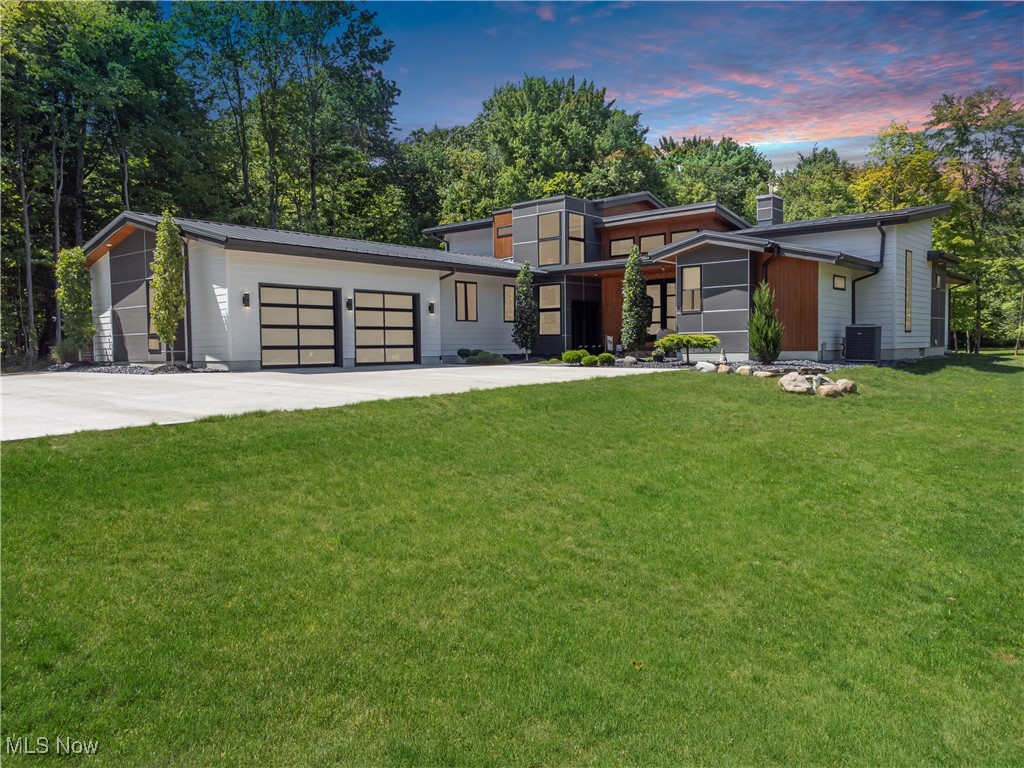 Modern Luxury Estate on 16+ Private Acres/Architect-Designed Masterpiece with 2-Level Entertainer's Deck
Experience unmatched privacy, luxury, and architectural distinction at this one-of-a-kind modern estate nestled on 16 pristine acres in Seville, Ohio (Medina City Schools). Built in 2019 with no detail spared, this custom designed residence blends clean contemporary lines with the serenity of nature, offering the ultimate in indoor-outdoor living.
Step inside to soaring 20ft ceilings in the great room, abundant natural light, and a flowing open-concept layout perfect for both entertaining and quiet relaxation. Designer finishes, wide-plank flooring, and panoramic windows showcase stunning views of the surrounding landscape from every room.
At the heart of the home is a chef's kitchen with premium appliances, custom textured cabinetry, and waterfall-edge quartz countertops - all seamlessly opening to a spacious great room and dining area warmed by a dual-fuel fireplace with electric and propane options.
Outside, an extraordinary 1750 square foot custom 2 level Trex deck w/hot tub area - built in 2024 - creates a show stopping space for gatherings, dining, and stargazing under wide-open skies. Whether you're hosting a summer soiree or sipping morning coffee while deer pass by, the experience is unforgettable.
The 16-acre parcel offers unlimited potential: gardens, trails, pasture, or simply peaceful space to roam. With a modern aesthetic rarely seen in rural Northeast Ohio. The serene Koi pond greets you at the entrance, setting the tone for the calm, Zen-like experience this property offers.
The full 15-course basement offers tall walls and preinstalled plumbing and electrical, ready for finishing to your own design.
Secluded, Yet Accessible to I-71, I-76, Medina and Wadsworth.