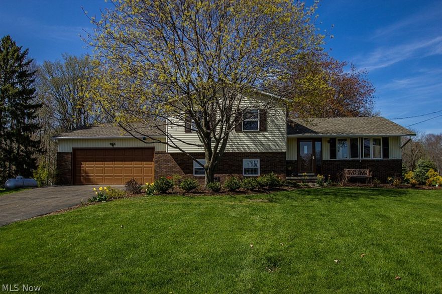 Must See 3 bedroom Split Level nestled on 3.5 private acres w/ the perfect combination of open green space & woods w/ creek! The warm & welcoming floorplan is great for gatherings and everyday living starting w/ the light filled living room w/ new hand-scrapped wood floors, custom kitchen w/ granite countertops, oak cabinets, ceramic backsplash, newer stainless appliances included & dining room w/ French door leading out to the spacious tiered deck.  A few steps down to the family room w/ patio access, cozy fireplace surrounded by new built-ins, updated full bath & mud room w/ plenty of storage space! Upstairs you will find 3 generously sized bedrooms & remodeled full bath. The finished basement provides a rec room, laundry room w/ washer/dryer (2014) & storage room w/ shelving. The impressive yard offers a deck, patio, 20x30 pole barn w/ horse stall, separate children's play area and path leading through the woods & creek! Many improvements have been done inside & out for to move righ