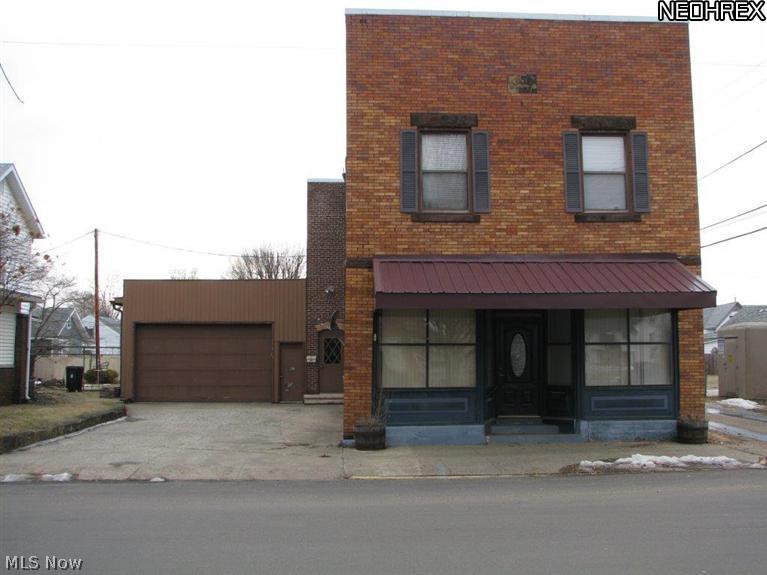 Affordable commercial building former West Lafayette post office. Currently the upstairs has a 2 bedroom apartment with full bath, kitchen, dining room, and living room. There are also 2 large garages. Lots of possibilities. This property offers approximately 5000 sq. ft.