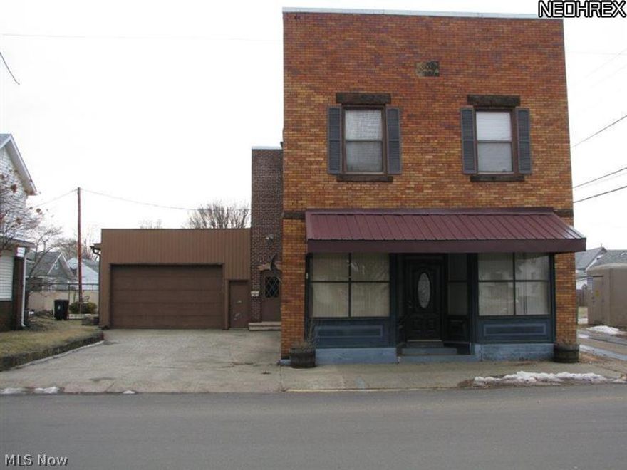 Affordable commercial building former West Lafayette post office.  Currently the upstairs has a 2 bedroom apartment with full bath, kitchen, dining room, and living room. There are also 2 large garages. Lots of possibilities. This property offers approximately 5000 sq. ft.