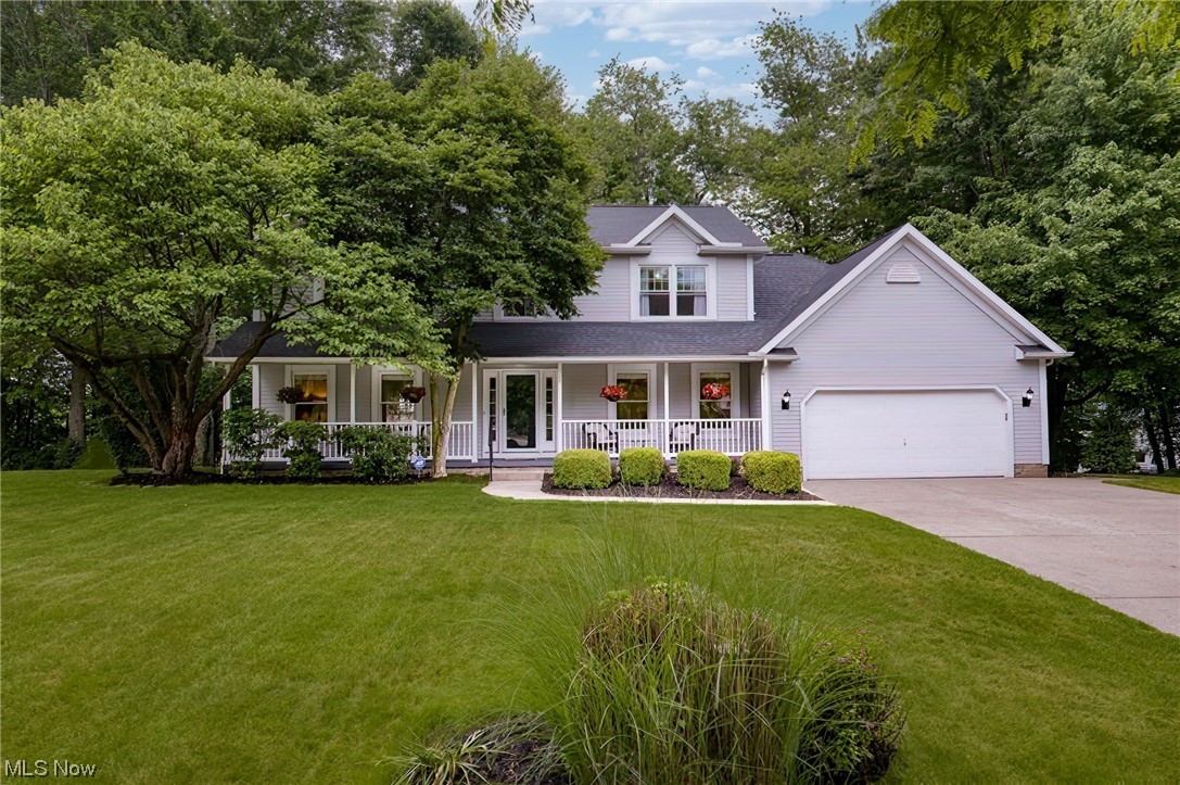 Nothing to do but move in and call it your own! This beautiful Ethans Green home has a finished WALKOUT lower level, and is located on a tree lined cul de sac street with only 9 homes! Enjoy lazy summer afternoons on the front porch or relax on the deck overlooking the private wooded back yard oasis which lends itself perfectly for entertaining! There is newer hardwood and high end laminate on the 1st and 2nd floors. Lliving room have French doors that open to the sunlit family room with double tray ceiling and gas or wbfp brick fireplace. Huge kitchen has all the bells and whistles including a seating island, granite counters, stainless appliances-double ovens,, gas cooktop, power range hood and dishwasher + built in desk and pantry closet. Remodeled powder room and 1st flr laundry room with cabinets and wash tub.. Vaulted primary suite has renovated bath with custom shower, granite vanity, soaking tub, skylight & walk in (2020). Two other bdrms have a walk in closet-one with attic