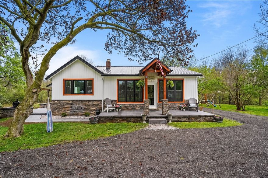 Welcome to 3241 Grill Rd, a beautifully updated ranch on three parcels totaling approx. 5.3 acres, complete with a private pond and mature trees. This 4-bedroom, 3-bath home offers over 2700  sq ft of finished living space, blending outstanding modern upgrades with farmhouse charm. The exterior showcases board and batten siding, black metal roof, stone accents, and rich wood trim, with a covered front porch and spacious concrete and stone patio ideal for outdoor living over looking the serene pond and wooded surroundings. Inside, the open-concept living and dining area flows into a large, modern kitchen with ample cabinetry and prep space. The primary suite features a fireplace, dual closets, and an updated en-suite bath. Two additional bedrooms and a full bath complete the main level. The finished lower level provides exceptional flexibility with a second kitchenette, bedroom with walk-in closet, bathroom, sitting room, and multiple bonus/storage areas—perfect for multigenerational living, guest quarters. Enjoy the peaceful natural setting with plenty of room for recreation, gatherings, and relaxation. This unique property offers the best of country living while remaining conveniently close to amenities. PARCELS INCLUDED IN THIS LISTING: PARCEL/APN : 25-00204 Approx. 233' x 933 & PARCEL/APN : 25-00202 Approx. 96 x 168 Apprx. 5.3 Acres.  (PARCEL NO LONGER INCLUDED IN THIS LISTING: PARCEL/APN : 25-00203  Legal Description: TR 18 LOT NW N OF RD 4.950A).  Schedule your showing today.