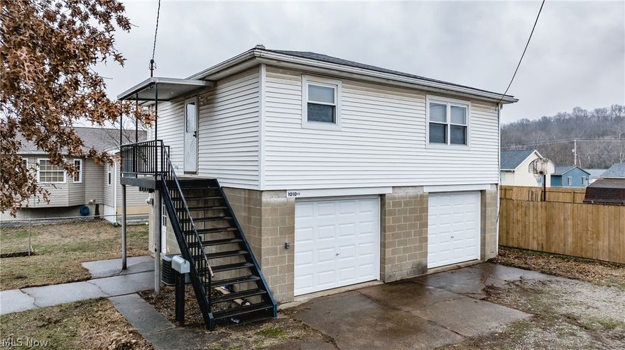 This home is above a Two stall garage with 2 bedrooms, one bath and the large living room is move in ready. There is new carpeting in the bedrooms and living room. The washer and dryer hook-up is in the first garage. Both garages have built-in wooden shelving for all your storage needs!!!