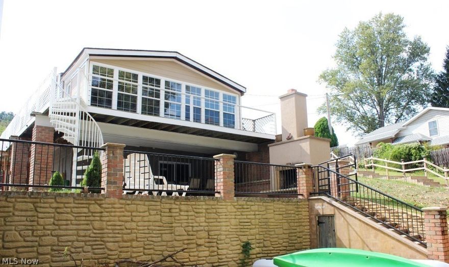 West Reservoir Lakefront on main chain of Lakes w/2 BR, 2 BA, approx. 1555SF, 3.5 car detached garage, mega parking & 2 docks (one with electric lift)* Many updates including kitchen with granite counter top, stainless appliances (refrig, gas range, microwave & dishwasher), soft close cabinets, glass tile back splash, breakfast bar, pantry & access to covered patio* 2 full updated bathrooms with ceramic floor* Large master bedroom with walk in closet, bath & access to 4 season sun room wrapped with windows & access to wrap around porch/balcony* Wonderful partially covered patio with outdoor wood burning fireplace & built in Kitchenaid gas grill plus a stamped patio* Other updates include siding (2-3 yrs.), windows (11-12 yrs.), softener (2 yrs.), hot water heater (1.5 yrs.), interior 6 panel Masonite doors, beveled glass front door, & electrical box* Storage building* Approx. 50' of waterfront* Sewer/private well* Immediate possession upon close* A must see!