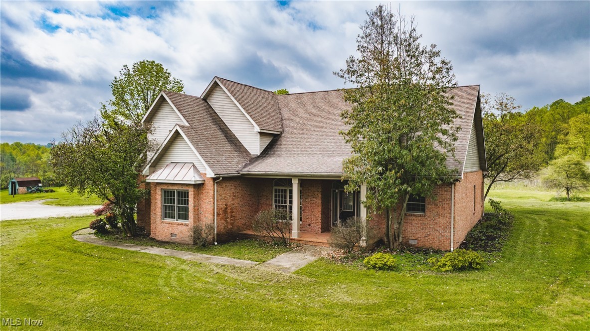 Custom brick home sitting on 2+/- acres setting outside city limits. This home is a 1.5 story but offers all first floor living with additional master suite on second level with loft area - this space is great for additional home office space. Front porch leads you to a stunning entry offering wood floors, open to formal living and dining room with arches and columns. Living room offers wall of windows overlooking screened porch and back yard view. Master suite offers walk-in closet, gas fireplace, entry to screened porch, whirlpool tub, walk-in shower and double vanity. Eat-in kitchen is stunning with an open view to family room with beautiful stone, gas fireplace. The custom kitchen offers pantry with pullouts, glass cabinet doors over appliance garage, raised bar and breakfast nook leading you to screened porch - this screened porch is perfect for an additional dining space, entertaining area, morning coffee and exits to back patio and yard. Main floors offers two additional bedrooms, 2nd full bath, spacious laundry room off kitchen that leads you to 3 car garage. Garage offers stairs to a bonus room that could easily be finished for additional bedroom or rec room. Storage room off garage is plumbed for additional bath and exits to back patio and yard - plenty of space for a pool. Beautiful hardwood floors, expansive ceilings.