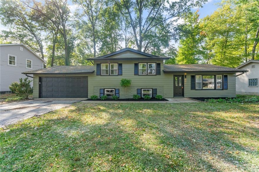 Welcome to this beautifully transformed home at 3913 Claridge Dr, Youngstown, located in the sought-after Austintown school district. Boasting three well-sized bedrooms and two full bathrooms, this home has undergone major renovations inside and out, including fresh exterior paint and cosmetic updates throughout. An open-concept layout welcomes you at the front door, a spacious living room flows into the kitchen and dining area, all with stylish vinyl plank flooring and clean, contemporary finishes. The kitchen shines with custom soft-close cabinetry, a center island, granite countertops, subway tile backsplash, and stainless-steel appliances. Enjoy morning light or evening views from the dining area, which opens to a back porch and overlooks a level backyard and shed. Upstairs, you’ll find all new carpet in each bedroom along with ample closet space. The full upstairs bathroom features a tub with tiled walls (accent tiled wall included), a new vanity, new toilet, and matching fixtures. The lower level adds even more livable space, offering a cozy family room carpeted for comfort, an additional full bath with walk-in shower and tile, laundry area, and utility room with high-efficiency forced air furnace & AC system, 40-gallon hot water tank, and 100-amp panel. Access from here also leads to the attached two-car garage. Additional highlights include aluminum siding, and a roof with dimensional shingles. With its serene setting, great neighborhood, and turnkey features, this home is a rare find.