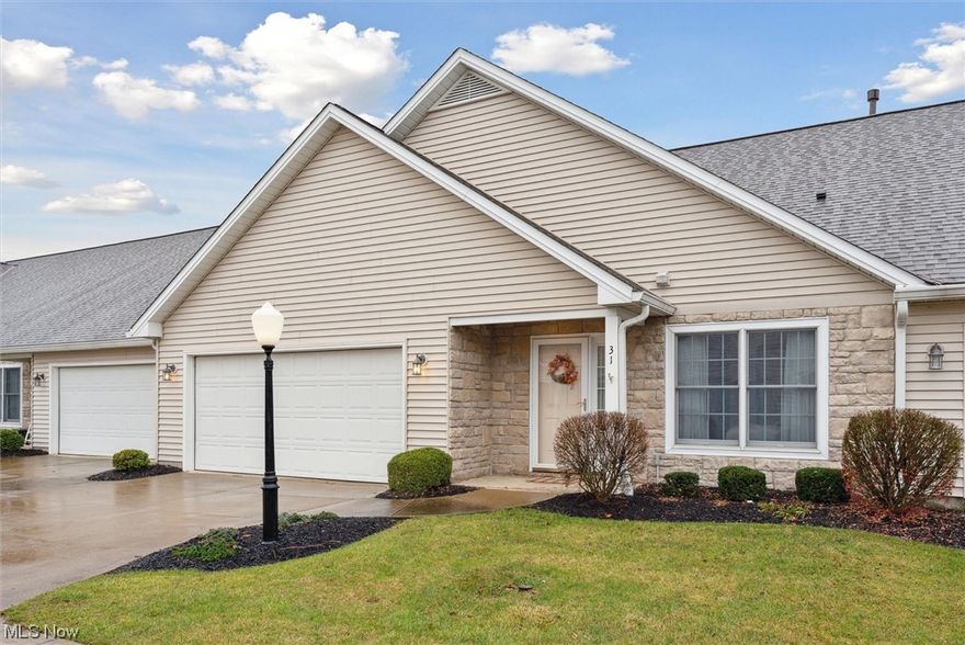 Offering the promise of an easier lifestyle, this one-story, beautiful, and cheery condo may just be what you have been looking for! Tucked away from the street and noise, it is located in one of the most highly desirable condo developments in this area. A small front porch leads into a wide entry hallway with a coat closet and a doorway to the garage. Off the hallway, is a guest bedroom that can double up as a home office. Arrive inside to a spacious and bright open floor layout, where the living, dining and kitchen spaces seamlessly flow into each other, allowing for wonderful gatherings of family and friends. The south-facing living room streams with light on sunny days, and has a gorgeous brick fireplace and hearth, and a wood mantle to show off your collectibles. A sliding door lets in additional light and opens to a patio for enjoying an outdoor meal or morning coffee or watching the native birds that frequent the birdfeeders. The large dining area has plenty of room for your dining buffet pieces, and a nearby closet is perfect to store your seasonal linens, albums and extra blankets. The kitchen has plenty of countertops and cabinets, a beautifully patterned tile backsplash, a breakfast bar for additional seating or a quick meal, and a pantry closet with shelving to cut down on your grocery trips. The primary bedroom is large enough to have a reading nook or a writing desk in addition to a bed, and has a walk-in closet, and an en-suite bathroom with a large tub and a separate shower! The second full bath can be accessed through the guest bedroom or the common areas for added convenience. Additional desirable features include accessibility features throughout, neutral colors throughout, tall energy-efficient windows that let in plenty of sunlight, central air, a fully equipped laundry room with storage shelving, and a large attached 2-car garage with plenty of storage space. Clean and move-in ready! Schedule your in-person or virtual tour today!