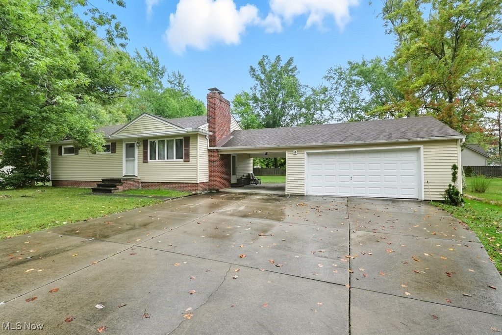 Take a look at this desirable, well maintained 3 bedroom ranch with oversized 2 car garage plus carport! The living room welcomes you to this lovely home, and features hardwood floors under the carpet and a woodburning fireplace. All three bedrooms also offer hardwood floors under the carpet and ceiling fans. The spacious kitchen offers oak cabinetry and all appliances, plus dinette area that opens to the back yard and patio. The living area is expanded into the lower level rec room which boasts a bar area and second woodburig fireplace! There is also a space for workout equipment or other hobbies, plus laundry area with washer and dryer. Updates include glass block windows, roof approx. 5 years, breakers, and recent duct cleaning. Immediate possession available!