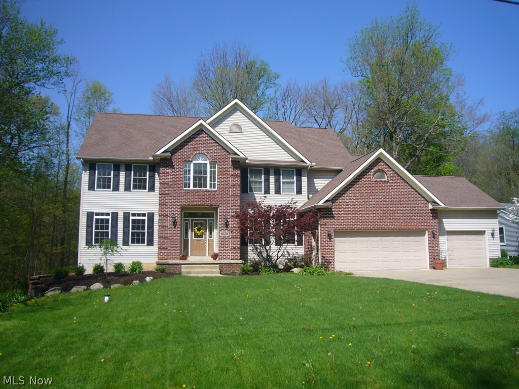 Unique custom-designed inviting open floor plan for easy family entertaining with oversize center-island kitchen, pull-outs, and large desk area near formal dining and family rooms. Upper deck gazebo off kitchen and abundant windows to enjoy nature all year! Attached 3 car garage with extra concrete turnaround. Textured knock-down ceilings, trayed ceiling with lots of crown molding. Brick gas fireplace, octagonal window, French doors separate parlor from family room. Spacious 1st floor laundry is handy to guest bath. Hardwood flooring in foyer and dining room with ceramic in the kitchen. Two stairways up offer more privacy for master areas plus two to the lower level for versatile living options. Large master bath has double sinks, soaking tub and separate shower. The 3448 sq ft does not include walkout full basement area with extra plumbing ready to finish your way. Sliders to an outdoor concrete patio. This extra large lot on a no outlet street. Warranty. A real treasure!