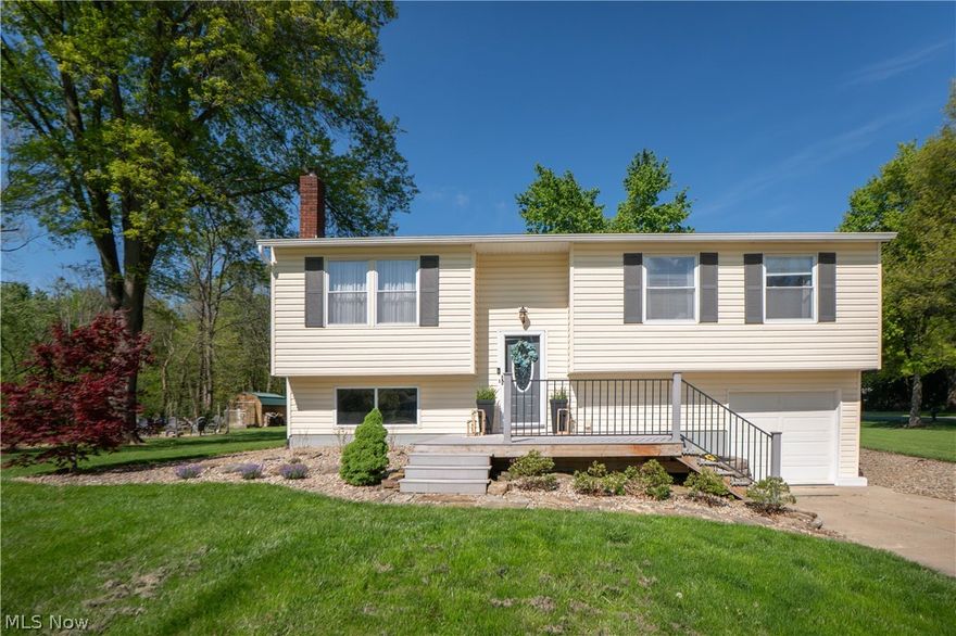 Tucked on a beautiful 0.69-acre lot next to a creek, this inviting bi-level offers comfortable living space, thoughtful updates, and wonderful indoor-outdoor appeal! A spacious front porch welcomes you inside to the living room, where soft carpet and a wood-burning fireplace with blower create a cozy place to gather. The living room flows into the eat-in kitchen featuring new LVT flooring, a dining area with built-in bench seating, beautiful cabinetry, tile backsplash, black appliances, double oven, and a new dishwasher and microwave. Sliding doors lead into the 3-season sunroom, a standout space added in 2021 with LVT flooring, vaulted ceilings, exposed wood beams, and corner-to-corner windows overlooking the backyard! Down the hall, three carpeted bedrooms provide comfortable retreats, including a primary bedroom with a large closet and charming wainscoting accent wall. The main full bath features a shiplap accent wall, and a tub/shower combination with subway tile surround added in 2026. The lower level expands the living space with a finished rec room, a large full bath with walk-in shower, wood accents and built-in shelving. Plus an unfinished area for laundry and storage. Outside, enjoy a rear deck, fire pit completed in 2023, treehouse playground, attached 16x15 shed build under the sunroom, and plenty of yard space to relax, play, or entertain!