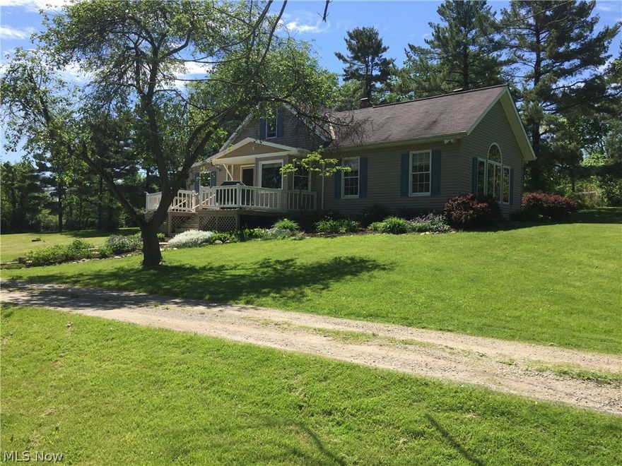 unique home on beautiful 5 acres with a view from every window, step down 20x20 great room with wood burning/gas stone fireplace, oak vaulted ceiling, custom window adds to charm and give a beautiful panoramic view, open to formal dining room with bay window, door to 15'x36' wood deck, galley kitchen with modern updates, bedroom on 1st floor,updated bath with beautiful cabinetry ( clothes chute to  basement laundry, 2 cozy bedrooms up, walkout basement, with newer high efficiency furnace and humidifier, 2 car detached garage 24 x 24 with opener attached to a huge building with heating and exhaust fan and overhead door to back, another section has storage for a tractor also with an overhead door, building is approximately 2000 square feet,  was used as a cabinet workshop in past, but is adaptable for many uses including a horse barn. this property offers a unique cozy home with a lot of character, 5 acres and many other possibilities. make an appointment to see it soon