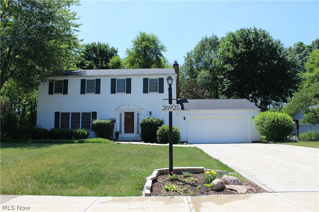Welcome home. This attractive colonial located on a quiet street in the heart of Westlake offers traditional design and unique accents. The large kitchen has hardwood floors, vaulted ceiling, a bay window, 2 pantries, granite countertops, and doors to the patio and screened-in porch. The cozy den has a beamed ceiling, sliding doors which lead to the patio, and a wood-burning fireplace which is framed by a custom mantle featuring a carved Gaelic blessing. Crown molding and upgraded hardware throughout the home. A long list of updates include the new concrete driveway and path from 2014 and a new garage door in June 2017. The basement boasts an incredible wet bar complete with all the bells and whistles, including a double sink, expansive storage, barkeepers fridge, and a beer tap in the wall! It's a must-see. Upstairs you'll find a master suite with a walk-in closet and beautiful, fully-renovated bath including custom vanity and hand-tiled shower, plus 3 more bedrooms and an additional full bath. The yard is large and open, framed with perennial beds. Behind the shed you'll find a gated vegetable garden with large compost and a rain barrel. The charming brick patio is sheltered by mature concord grape vines that produce excellent shade and delicious yearly harvests. All appliances stay, including a refrigerator/freezer/kegerator and tankless water heater!