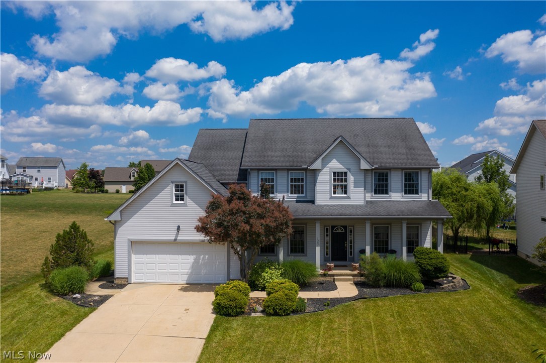 1307 Windward Ln, Kent, OH 44240 located in highly sought Forest Lakes Development on Kent & Stow border, easy trek to downtown Kent in an AWESOME community w/ 43 acre Nature Preserve +/- includes 2 fishing ponds, trees & walking trails, park, playground, & cool neighborhood! Custom built one owner home by Lillibridge Homes Inc. w/ wide span front porch to relax under cover, huge rear deck w/ plenty of seating areas, patio w/ trellis & feature pond! Awesome 4 bedrooms w/ 2.5 bathrooms, oversized 2 car garage w/ builtin shelving, an almost finished basement lower level, bonus hearth room w/ double sided fireplace that is also on Family Room side w/ beautiful window seat featuring extra storage & lots of natural light! Kitchen has 2 tone cabinetry layout ready for your chef, features maple cabinets by Kraftmaid, appliances, hearth room w/ fireplace & access to both rear deck & 1st floor laundry! Dining Room is accented w/ Crown Moulding, Wainscotting & Chairrail as well as the front Livi