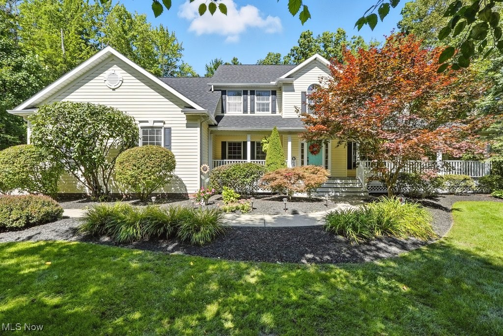 Nestled at the end of a quiet cul de sac in a desirable Newbury, Ohio neighborhood, this stunning Southern Living style Colonial sits on a premium 3 acre wooded lot offering privacy, natural beauty, and timeless charm. A welcoming wraparound porch sets the tone for this custom-designed home that truly has it all. Step inside to an elegant Foyer that opens to a formal Dining Room, Piano Room/Living Room, and expansive Great Room. A light-filled Sunroom with vaulted ceilings provides serene views of the picturesque backyard. The spacious, well-appointed Kitchen is perfect for entertaining and flows into a Mudroom and Laundry Room- Washer and Dryer included. A versatile Den, or Fifth Bedroom and a full bath complete the thoughtfully designed first floor. Upstairs, the luxurious Primary Suite features a spa-like bath and a beautifully customized walk in closet with built in shelving, drawers, and generous hanging space- offering both elegance and boutique style. Three additional bedrooms and a large full bath provide ample space for family or guests. The home has a three car Garage and full unfinished basement. The home has many updates. New Roof and Gutters-August, 2025, Furnace-2024, updated electrical -2025, and Well Pump 2025. See feature sheet for complete updates. This exceptional home combines classic architectural detail with modern comfort in an idyllic setting.