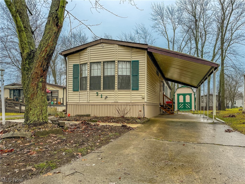 Nestled within a serene wooded 55 and over community in Elyria lies this charming mobile home offering a peaceful retreat. Boasting two bedrooms and two bathrooms, this cozy abode welcomes you with the convenience of a fully equipped kitchen showcasing modern appliances. Shed included to accommodate your storage needs. Embrace the tranquility of a quiet community featuring a lake, vibrant party hall, a rec room for entertainment, a dog park and pickleball court. A perfect blend of comfort and leisure.