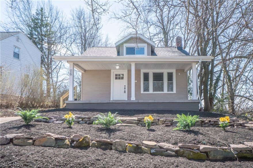 Updated and full of charm, this inviting bungalow offers stylish finishes, functional living space, and great curb appeal in Akron. A large covered front porch welcomes you inside to the bright entryway with coat closet, leading into a comfortable living room with a decorative electric fireplace and easy flow into the dining area. The dining space features a built-in bench with storage, while the beautifully refreshed kitchen offers stainless steel appliances, new cabinetry, quartz countertops, tile backsplash, and a built-in spice cabinet. Two main-level bedrooms share a full bath with a tiled tub surround, wood shiplap accents, and a distinctive decorative ceiling in the shower. Upstairs, the spacious bungalow-style third bedroom provides flexible space for a primary suite, home office, or additional living area. The partially finished lower level adds even more versatility with a rec room, full bath with standing shower, laundry, and storage space. Outside, enjoy new landscaping, a covered rear porch, and a detached 1-car garage. Public water, public sewer, and central air complete this move-in ready home!