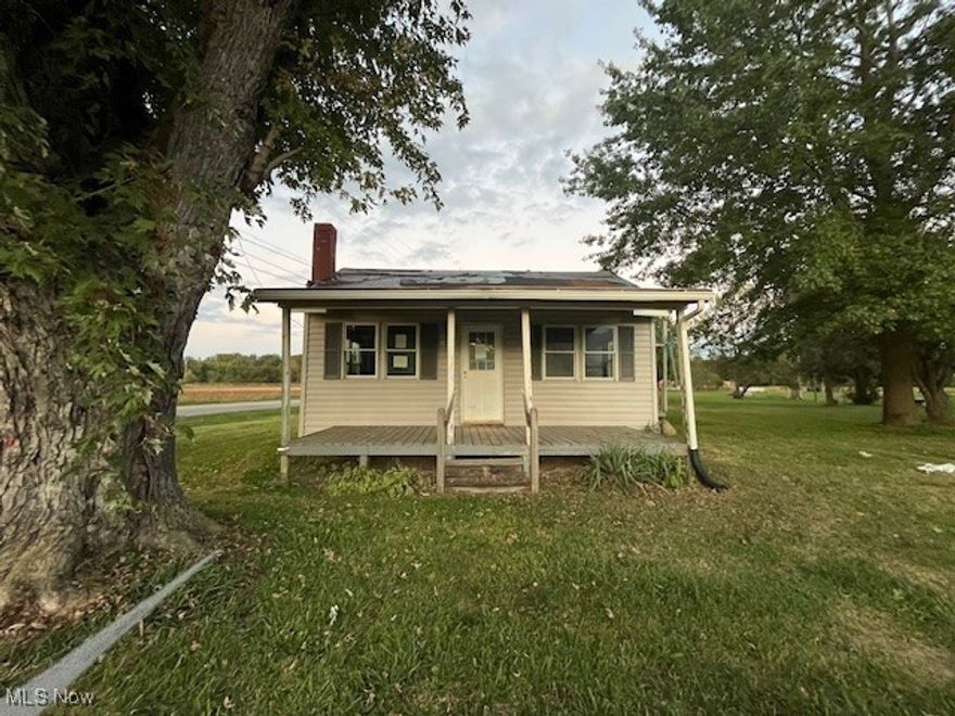 Great starter home with nearly a blank slate for you to make it your own and move in! Two bedrooms with open living room and dining room layout. The home is cozy but the large lot allows plenty of room to add on.  Covered front porch and a side deck.  Two out buildings/garages 34' x 18' & 36' x 24' and a large yard. Several new windows. This home just needs the right vision and updates to shine. All on a 1.36 acre corner lot in the country! So much potential!