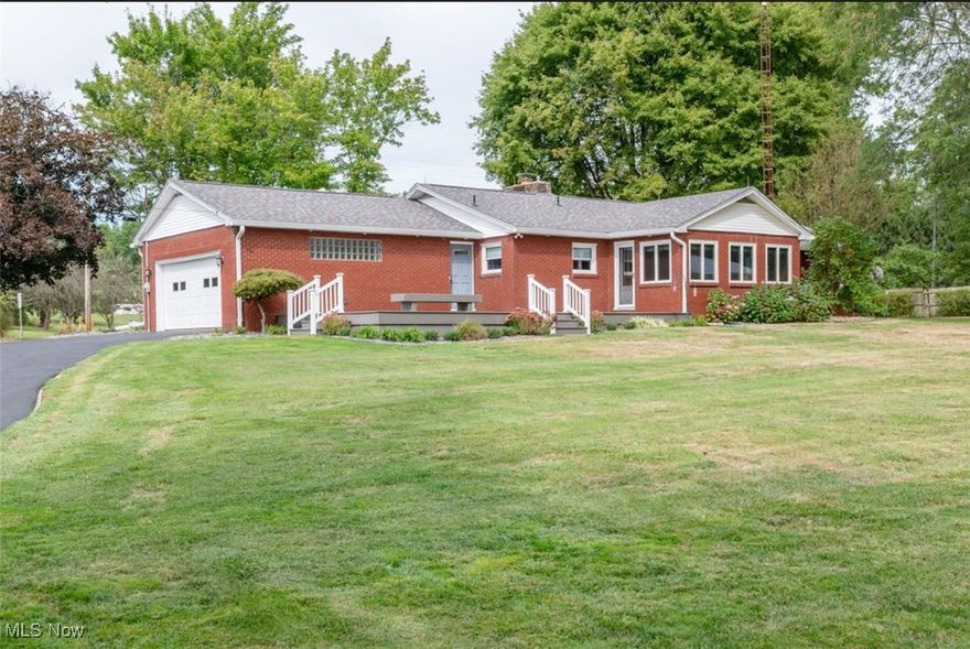 Stunning brick ranch home on 1.35acres. Quality upgrades is what you will find in this 4 bedroom home; from the moment you step foot onto the large composite deck (2014) and enter into the fully remodeled (2011) custom kitchen you will see only high-end, quality finishings. The kitchen features hickory cabinets, quartz countertops, beautiful lighting that offers a warmth to the heart of the home. A sunroom leads you to the large composite deck and back yard with a view of the property. The front room/living room has a perfectly placed wood burning fireplace with insert (2023) and custom window blinds on the large picture window. The full bath, remodeled in 2010, is convenient to the three bedrooms. The master bedroom , could be a family room, offers a well appointed half bath and large closets and is situated on the opposite end of the layout. The basement hosts great storage area, carpeted area with half bath, full tile walk in shower, laundry room and open space for all your needs. For your big toys enjoy the 3 car detached garage with concrete floor & electric. Updates include: roof 2024 , deck & landscaping 2014 , furnace & AC 2018 , well 2023 , hot water tank & softener 2023 , windows 2023 , upgraded 220amp electric