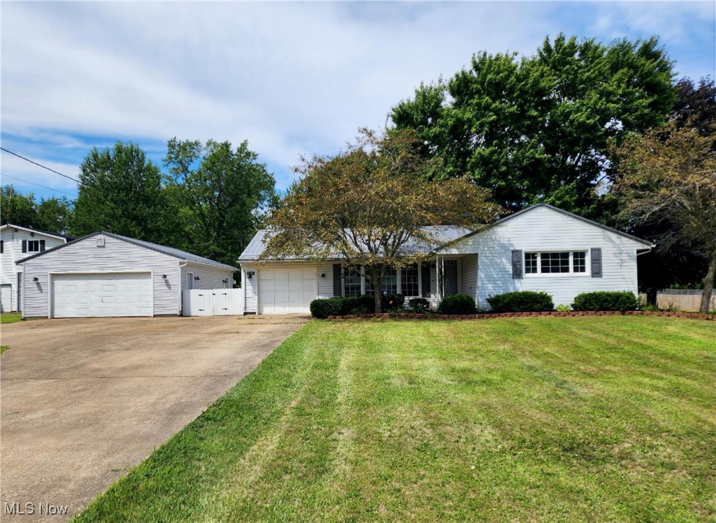 If you enjoy working outdoors or spending time in the garage, this property is must-see. Nestled near the end of a quiet dead-end street, this welcoming 3-bedroom ranch sits on nearly 0.73 acres and features both an attached heated one-car garage and a heated two-car detached garage—perfect for year-round projects. A concrete patio between them offers a practical yet inviting space to enjoy. Inside, solid 2-inch hardwood oak floors span most of the home, beautifully paired with painted oak cabinetry in the kitchen and bathroom. The partially finished basement adds character with a spacious recreation room and a billiard table—which will convey with the home. Additional highlights include a well-equipped laundry room with generous cabinetry, a utility sink, and a washer and dryer that stay. Recent updates include a new butcher-block countertop, stainless-steel sink, Delta kitchen faucet, and tiled backsplash in kitchen July 2025, new vinyl flooring in the morning room July 2025, hot water tank and sump pump replaced with new in January 2021, water softener replaced with new in October 2023, and both laundry machines (washer and dryer) replaced with new in the summer of 2023. Exterior Security Lighting surrounds the home, and the Ring Doorbell at the front entrance offers added peace of mind. The six-year-old metal roof ensures durability and low maintenance, while the shed, with electricity, provides even more flexible workspace. Schedule your showing today—this exceptional property won't last long!