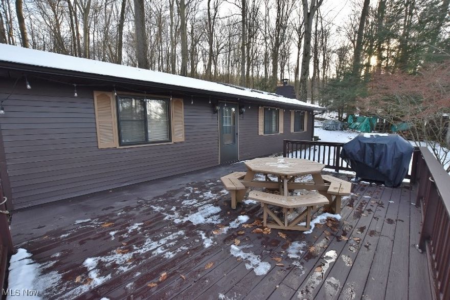 Charming and affordable lake cottage located in the highly desirable Atwood Glens community at scenic 1,540-acre Atwood Lake. This inviting two-bedroom home offers comfortable indoor living along with excellent outdoor space for family enjoyment and entertaining. The property backs to lush public woodlands, offering added privacy and opportunities for hiking and exploring. The spacious living room features vaulted, beamed knotty pine ceilings, three skylights that provide abundant natural light, and a cozy wood-burning stove highlighted by rustic barn beam details. The eat-in kitchen is mostly open to the living area, creating a functional and social layout that keeps the cook connected to the conversation. All kitchen appliances—including refrigerator, range, and dishwasher—are included. Two generously sized bedrooms and a full bath with tub/shower combination, along with a convenient laundry closet complete the interior living space. The home also offers a partial unfinished basement housing mechanicals, 2nd toilet & sink & limited additional storage. Outdoor living is enhanced by a large raised deck, ideal for relaxing or hosting gatherings. Residents may enjoy access to Atwood Glens community beaches with a minimal annual membership, and boat dock availability provides the opportunity to fully enjoy the lake lifestyle. A 10x12 storage shed offers ample space for lawn and boating equipment. The 2025 MWCD lease rate is $1,875. Be sure to view the Matterport 3D virtual tour. This is a wonderful opportunity to own an affordable lake retreat—schedule your private showing today.