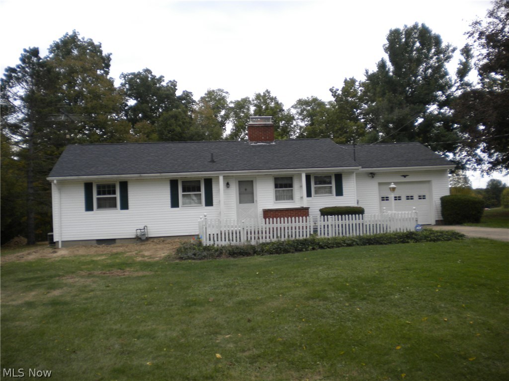 Enjoy the comfort of a well maintained, 3 bedroom ranch in the corner of the Village of Garrettsville. Enter through a charming entry with a slate floor. The 3 bedrooms have hardwood floors and there is cork in the hallway. This home has a full basement, recently waterproofed, a one car attached garage, central air, concrete drive and great yard. The living room has a fire place surrounded by knotty pine wood and a huge window with a peaceful scenic view of the back yard. Wonderful home!