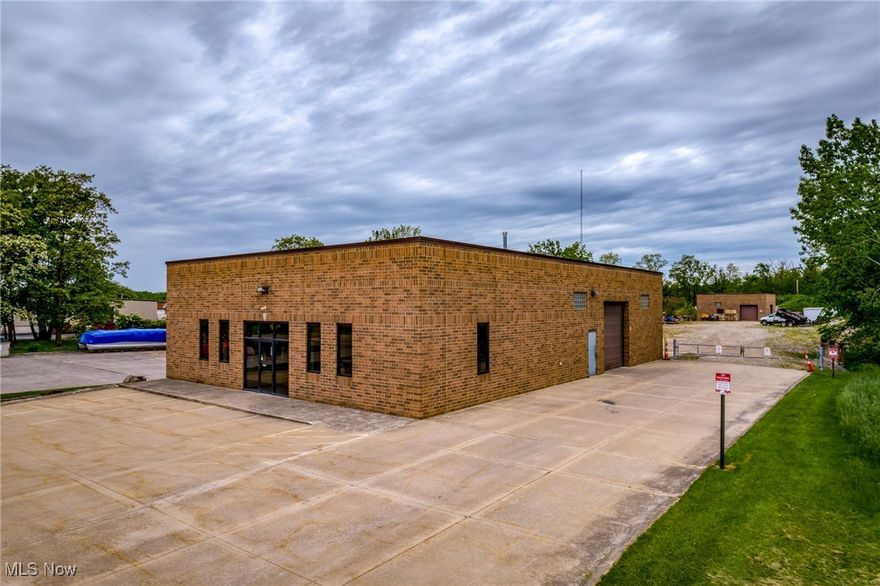 Two commercial brick buildings totaling 5,600 sqft on a 1+ acre lot in North Royalton Industrial Park. The handsome full-brick main building includes approximately 1,600 sqft of finished office space (reception area, 4 offices, a conference room/fifth office, kitchenette, and 2 half-baths) and roughly 2,500 sqft of heated warehouse space with three-phase electric and two drive-in doors (12' W x 12' H and 14' W x 12' H) that accommodate large trucks, trailers, and heavy equipment. Built in 2006, the partial brick detached garage/warehouse has 1,440 sqft with two drive-in doors (10' W x 10' H and 14' W x 10' H) offering additional enclosed parking space and storage for valued assets. Combined warehouse space of roughly 3,940 sqft. Exterior grounds of this 1.08-acre property include 7,500 sqft of paved surface (includes 8 lined parking spaces) and >30,000 sqft of gravel surface—tons of space for parking, trailers and maneuvering. Located near the front of a thriving industrial park offering exceptional connectivity—strategically 7 min to I-71, 12 min to I-77, and 11 min to the Ohio Turnpike—this location is ideal for industries prioritizing accessibility and timely deliveries! This adaptable property is well-suited for a variety of industrial ventures, from manufacturing to trade contractors and warehousing to logistics, presenting unlimited potential for businesses seeking to launch or grow their operations. The perfect location to embark on or expand your business ventures!