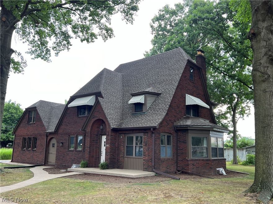 Beautiful brick 2 story home with 3 bedrooms, 1.5 baths on a double lot.  Original wood doorway leads into the entry foyer setting the stage for the charm and character of this quality home.  Well maintained with spacious rooms and original woodwork.  Fresh paint and new floor coverings throughout.  Updated light fixtures.  Large living room features marble wood burning fireplace with oak mantel.  Quality oak kitchen.  Formal dining room features French doors leading to the sun room with wood beamed cathedral ceilings.  Full bath updated with whirlpool tub and separate shower.  Walk up attic could be additional living area or storage space.  Rustic rec room boasts a stone fireplace.  2 car attached garage with additional attic space.  Huge patio area, great for entertaining in the mature treed, private backyard with 10 X 14 shed.  Conveniently located on the corner of East Iron Avenue and North McKinley Street.  Taxes reflect the seller receiving a homestead credit of $394.72 annually.  Masonry repairs in 2024 by Superior Basements, electrical updates by Maxx Electric.