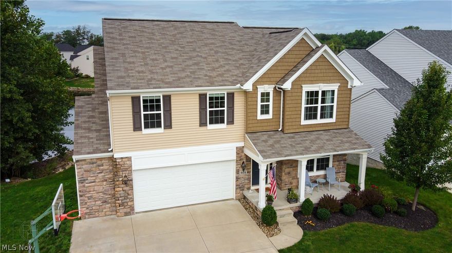 Wow, this home won't disappoint! Gaze through a wall of windows that overlook the lake, especially on those beautiful evenings with glowing sunsets! The view from the stamped concrete patio (complete with gas bonfire pit and built in bench) or from the lighted, oversized (16' x 16') Timbertech composite deck is just as spectacular! Considering this home is only 8 years old and all of the work and features the sellers have added, this home is better than building a brand new one! 4 large bedrooms, including a first floor master suite, 3 and 1/2 baths complete with hardwood floors through out most of the first floor, and a large great room with 10' ceilings that overlooks the stunning back yard are just many of the features this home offers. The walk out basement has a large recreation room that walks out onto the stamped concrete patio, is also great for entertaining. Despite so much of the basement (9' ceilings) being finished, there is still plenty of room in the 2 storage rooms (24x2