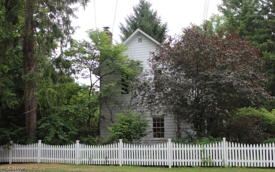 You will fall in love with this charming Western Reserve Colonial.  Front door opens to a long foyer with windows running the full 20 feet bringing in the outdoors.  Enter the bright kitchen with glass front upper cupboards and hickory floors.  Plenty of counter and cupboard space with open kitchen floor plan to move freely while cooking.  Relax at the kitchen table and enjoy beautiful landscaped grounds.  Settle in the cozy living room with a warm fire aglow.  Go up to the second floor on smooth hickory stairs as you retire to enjoy a book in the sitting room.  Open the storage closet in the sitting room that has built in drawers and a shelf to hide away a TV for viewing.  Both bedrooms have large windows to bring in the light.  The master bathroom features a claw foot bathtub with a pane glass door to the linen closet.  The backyard invites you to your own private living space with plenty of room for outdoor entertaining on the patio, corn-hole in the yard, or simply enjoy the establ