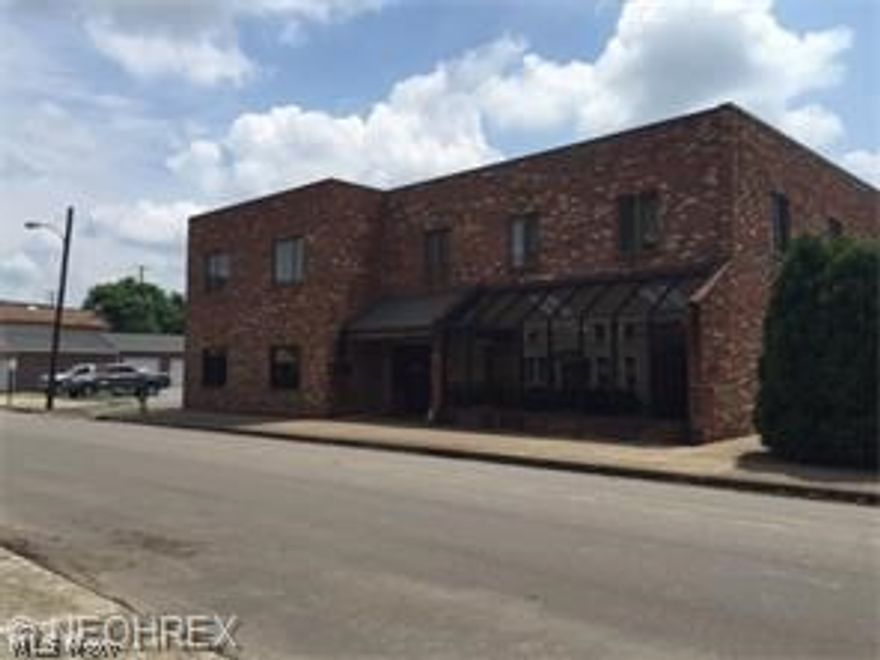 This building has FOUR apts upstairs.  The bottom floor is set up for  medical office space, but could be used for many things.  There are four exam rooms, lobby, kitchen, office area with full bathroom.  Lobby has restroom.